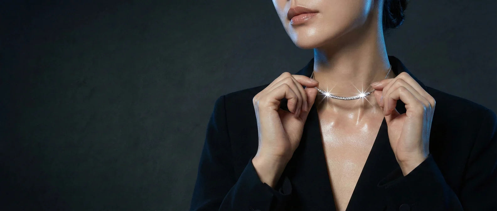 Elysia lab-grown gemstone necklace collection featuring a blue sapphire teardrop pendant, a rose pink round solitaire necklace, and a red emerald-cut gemstone necklace with diamond halo on a white background.